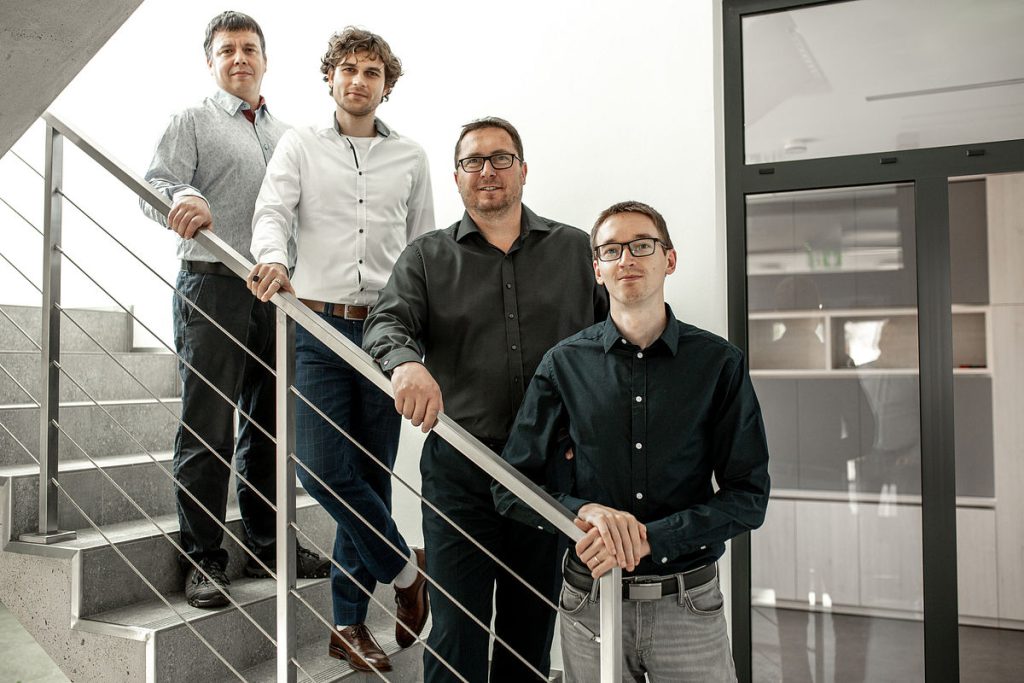 Four members of the RF SPIN team on the staircase of the company building