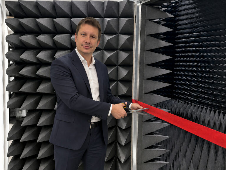 Red ribbon cutting at the anechoic chamber of RFspin Calibration Laboratory, marking its ISO/IEC 17025 accreditation
